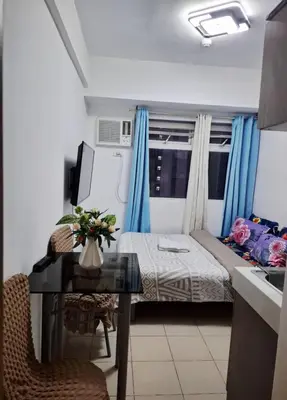 a small room with a bed and a desk with a desk at Urban Deca Tower Edsa Mandaluyong Staycation Condotel in Manila