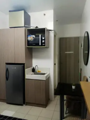 a small kitchen with a sink and a microwave at Urban Deca Tower Edsa Mandaluyong Staycation Condotel in Manila