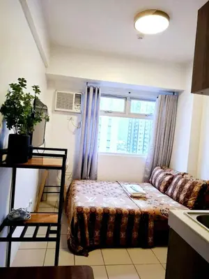a small room with a bed and a window at Urban Deca Tower Edsa Mandaluyong Staycation Condotel in Manila