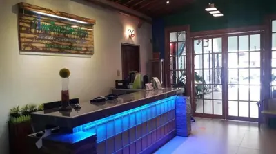 a restaurant with a bar with blue lights on it at Time Travellers Hotel in Manila