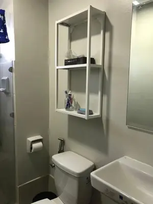 a white bathroom with a toilet and a sink at Paranaque Manila Bloom residences in Manila