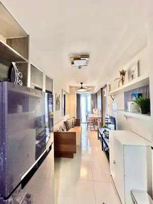 a kitchen and living room with a couch and a table at Mall of Asia MOA S Residences , IKEA Pasay , NAIA Airport , Manila Bay in Manila