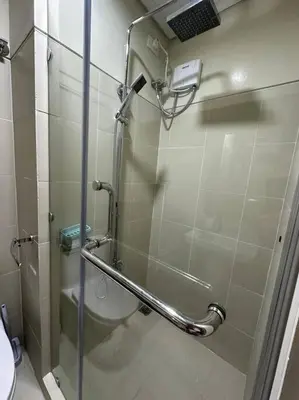 a shower with a glass door in a bathroom at Mall of Asia MOA S Residences , IKEA Pasay , NAIA Airport , Manila Bay in Manila