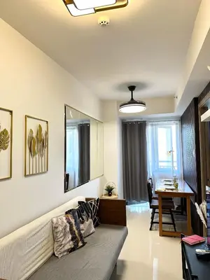 a living room with a couch and a table at Mall of Asia MOA S Residences , IKEA Pasay , NAIA Airport , Manila Bay in Manila