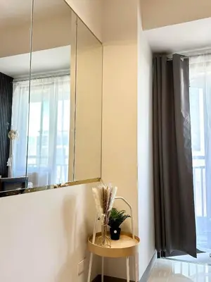 a bathroom with a mirror and a table with a plant at Mall of Asia MOA S Residences , IKEA Pasay , NAIA Airport , Manila Bay in Manila