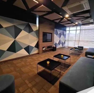 a room with two tables and a flat screen tv at 2 Bedroom Loft at Twin Oaks Place in Manila