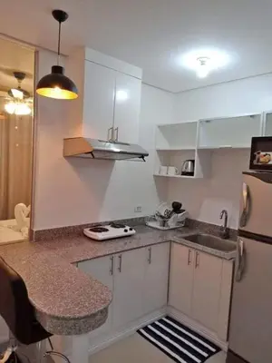 a small kitchen with a sink and a refrigerator at Book Now for Free Pool And Sauna Access Inside Prime Location Of Manila near US Embassy, NAIA, Makati, BGC, Mall of Asia, Chinatown. Immerse in Sea View Balcony for Limited Time Offer This Month Click Here Now in Manila