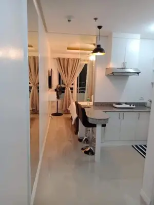 a kitchen with a table and a dining room at Book Now for Free Pool And Sauna Access Inside Prime Location Of Manila near US Embassy, NAIA, Makati, BGC, Mall of Asia, Chinatown. Immerse in Sea View Balcony for Limited Time Offer This Month Click Here Now in Manila