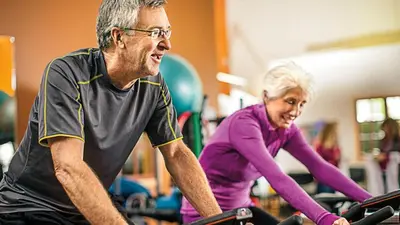 an older man and an older woman on bikes in a gym at Book Now for Free Pool And Sauna Access Inside Prime Location Of Manila near US Embassy, NAIA, Makati, BGC, Mall of Asia, Chinatown. Immerse in Sea View Balcony for Limited Time Offer This Month Click Here Now in Manila
