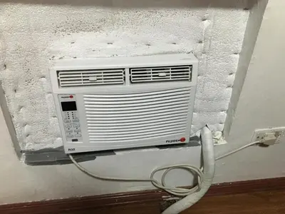 a air conditioner is attached to a wall at Stay in Manila, Cambridge Village in Cainta