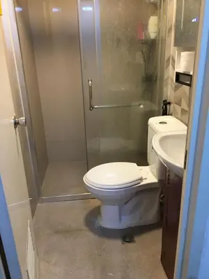 a bathroom with a toilet and a shower and a sink at Stay in Manila, Cambridge Village in Cainta