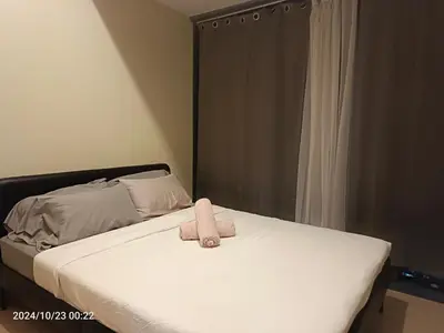 a bed with a stuffed animal on top of it at Eastwood Staycation Home with Stunning City View minimum 2nights stay in Manila