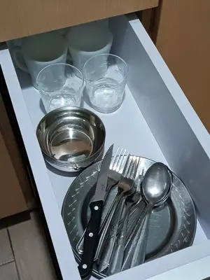 a drawer with a plate and utensils on it at Eastwood Staycation Home with Stunning City View minimum 2nights stay in Manila
