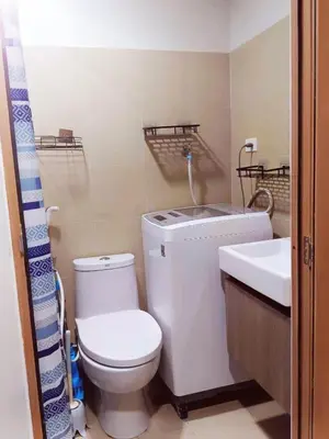 a bathroom with a toilet and a sink at Condo near Mall of Asia in Manila