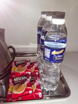 a bottle of water and some snacks in a refrigerator at Condo near Mall of Asia in Manila