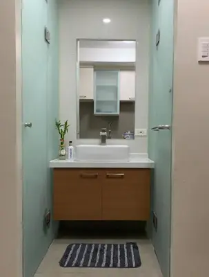 a bathroom with a sink and a mirror at Milia Condo w/ Free use of Swimming pool & Gym in Manila