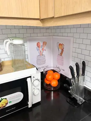 a kitchen counter with a microwave and some oranges at Tropical Oasis w/ the best view of BGC + Netflix in Manila