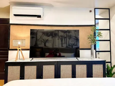 a room with a large mirror on the wall at Tropical Oasis w/ the best view of BGC + Netflix in Manila