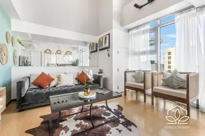a living room with a couch and a table at Tropical Oasis w/ the best view of BGC + Netflix in Manila