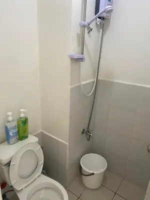 a bathroom with a toilet and a shower at Pierrecondotel in Manila