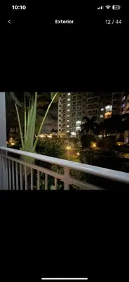 a view of a city at night from a balcony at Simple Yet Special n SOUTH RESIDENCES in Manila