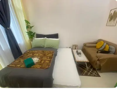 a living room with a bed and a couch at Simple Yet Special n SOUTH RESIDENCES in Manila