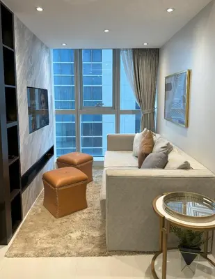 a living room with a couch and a large window at Stylish 2br with View at BGC Uptown Parksuites 29a in Manila