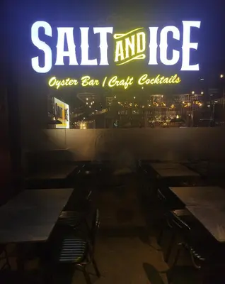 a sign for a restaurant with tables and chairs at Stylish 2br with View at BGC Uptown Parksuites 29a in Manila