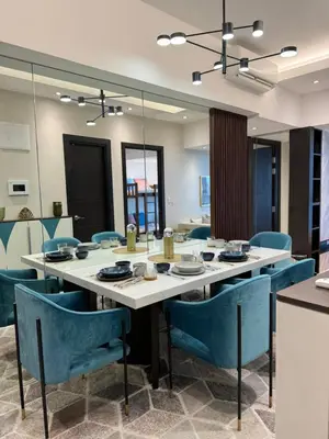 a dining room with a large table and blue chairs at Stylish 2br with View at BGC Uptown Parksuites 29a in Manila