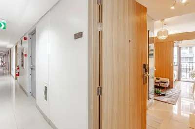a hallway with a door leading into a room at ClaySky Staycation S2T1-Cozy & Homey 1BR Apartment near MOA facing Pool with Own Parking with Netflix, HBO Max YouTube Premium & up to 200mbps Wifi in Manila