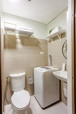 a bathroom with a toilet and a sink at ClaySky Staycation S2T1-Cozy & Homey 1BR Apartment near MOA facing Pool with Own Parking with Netflix, HBO Max YouTube Premium & up to 200mbps Wifi in Manila