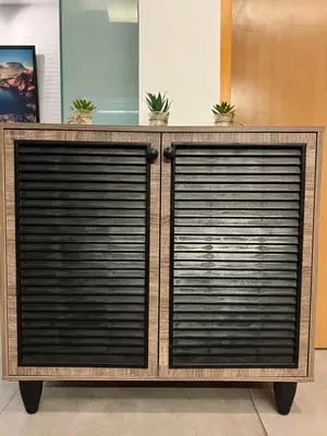a dresser with two garage doors in a room at Comfty, Chic & Spacious Room with Parking & WiFi in Manila