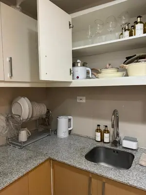 a kitchen with a sink and a counter top at Staycations Up Above 14 @ BGC 1BR in Manila