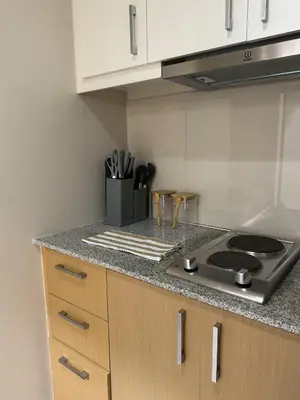 a kitchen with a stove and a counter top at Staycations Up Above 14 @ BGC 1BR in Manila