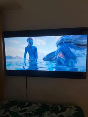 a television screen with a man in the water at Fame Residences Mandaluyong 1 Bedroom City View in Manila