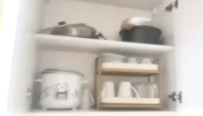 a white shelf with dishes and a pot on it at Shell Residences by Amonbrey Suite nr airport in Manila