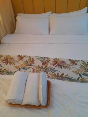 a bed with two towels and two pillows on it at Shell Residences by Amonbrey Suite nr airport in Manila