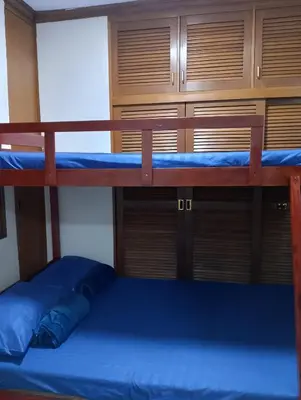 a bedroom with two bunk beds with a blue bed at Makati Transient Condo 3BR with Balcony, Wifi in Manila