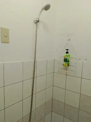 a room with a shower with a green bottle in it at Makati Transient Condo 3BR with Balcony, Wifi in Manila