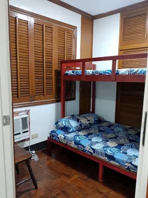 a bedroom with two bunk beds and a window at Makati Transient Condo 3BR with Balcony, Wifi in Manila