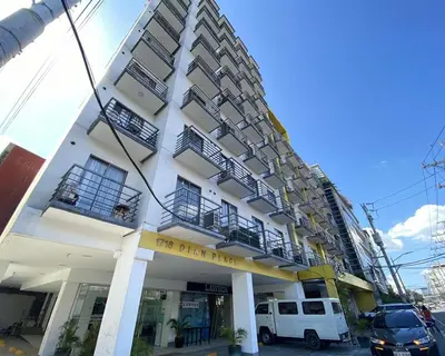 a white building with a building with a balcony at Dian SUITES 1 in Manila
