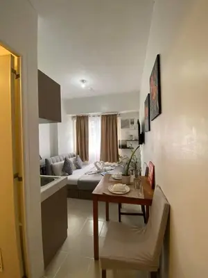 a living room with a couch and a table at Buenbyahe Cozy Affordable Place at Urban Deca Tower along EDSA Shaw MRT walking distance in megamall in Manila