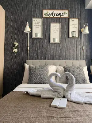 a bedroom with a bed with two swans shaped towels at Buenbyahe Cozy Affordable Place at Urban Deca Tower along EDSA Shaw MRT walking distance in megamall in Manila