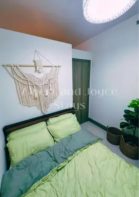 a bedroom with a bed and a chandelier at Emma Mattress 1BR CONDO @ FAME (pool & city view) in Manila