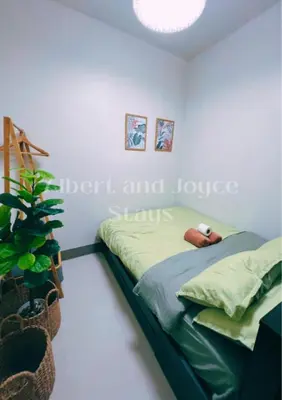 a bedroom with a bed and a potted plant at Emma Mattress 1BR CONDO @ FAME (pool & city view) in Manila