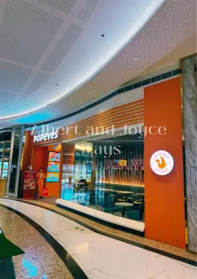 a store in a shopping mall with a sign on it at Emma Mattress 1BR CONDO @ FAME (pool & city view) in Manila
