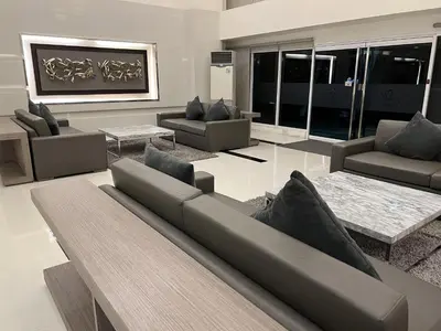 a living room with a couch and chairs and tables at Cozy Studio with SM Jazz Mall 