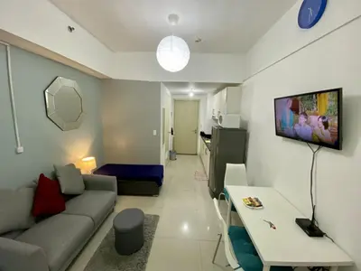 a living room with a couch and a table at Cozy Studio with SM Jazz Mall 