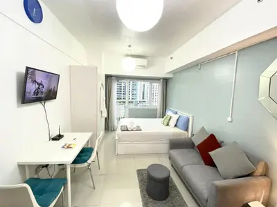 a living room with a couch and a bed at Cozy Studio with SM Jazz Mall 