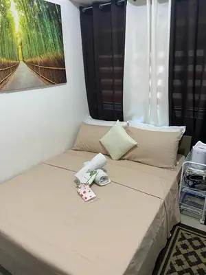 a bed in a room with at pierrecondotel in Manila